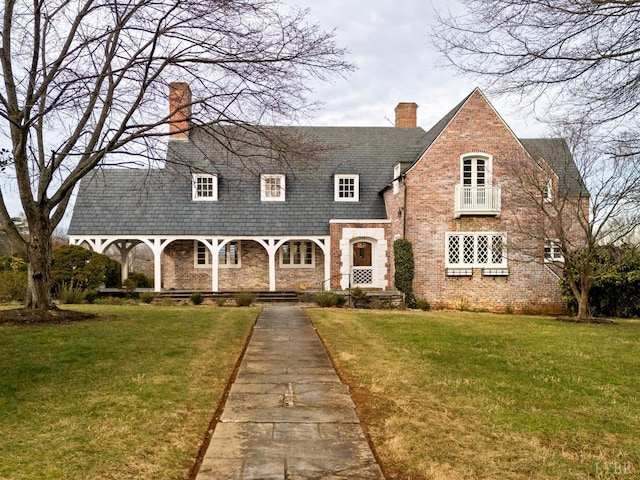 113 Oakwood Pl, Lynchburg, VA 24503 - tudor house with a chimney, a front lawn, and stone siding