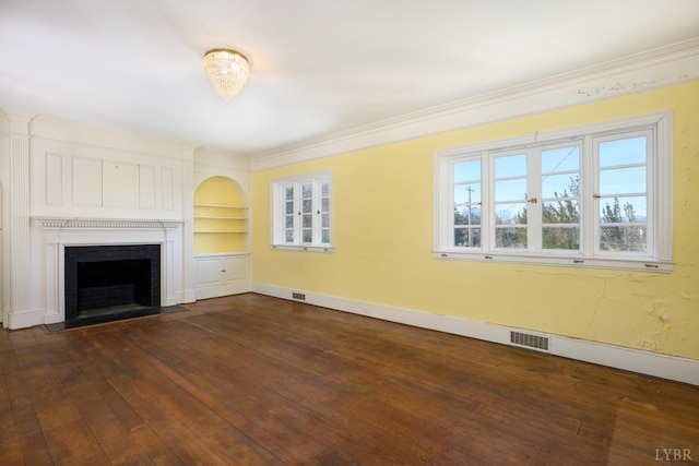 unfurnished living room featuring baseboards, ornamental molding, visible vents, a fireplace with flush hearth, and dark wood-type flooring