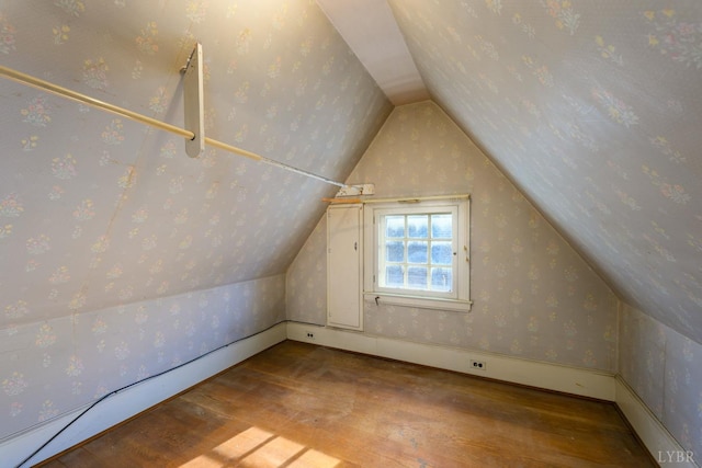 bonus room with lofted ceiling, hardwood / wood-style flooring, and wallpapered walls