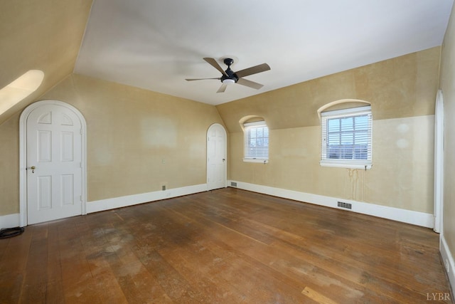 unfurnished room featuring baseboards, ceiling fan, wood-type flooring, and visible vents