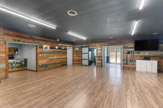 273 Riverbend Rd, Altavista, VA 24517 - miscellaneous room with a barn door, wood finished floors, and visible vents