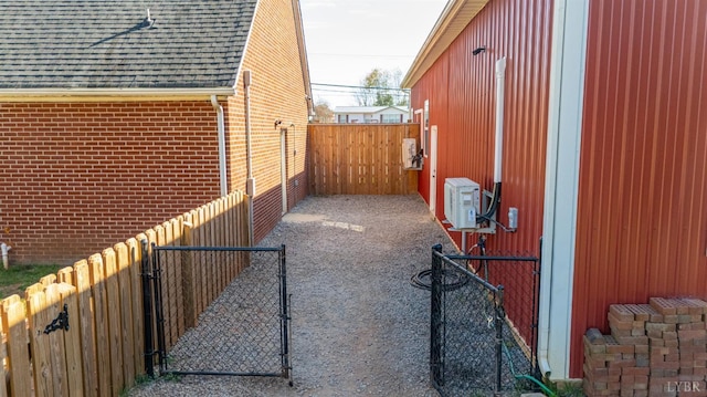 273 Riverbend Rd, Altavista, VA 24517 - view of property exterior featuring a gate, fence, a shingled roof, ac unit, and brick siding