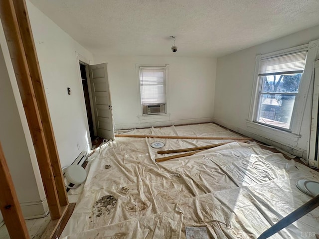 1711 Floyd St, Lynchburg, VA 24501 - spare room with a textured ceiling, plenty of natural light, cooling unit, and a baseboard radiator