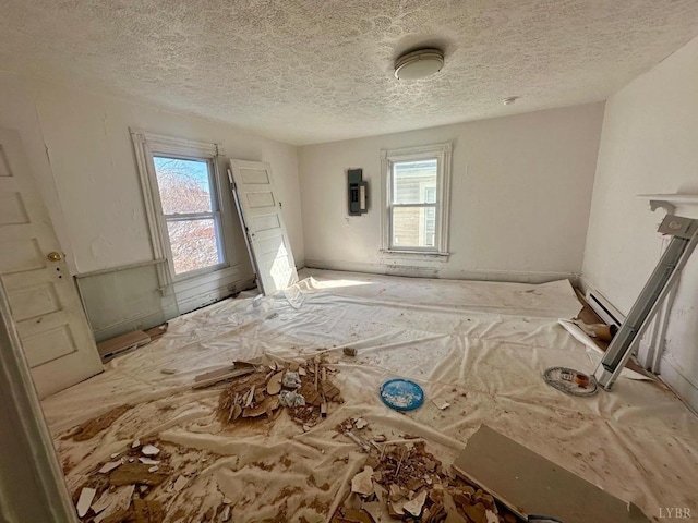 1711 Floyd St, Lynchburg, VA 24501 - empty room featuring plenty of natural light, a textured ceiling, and a smoke detector