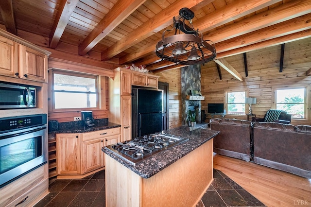 2766 Camden Rd, Big Island, VA 24526 - kitchen with a center island, appliances with stainless steel finishes, wooden walls, and light brown cabinetry