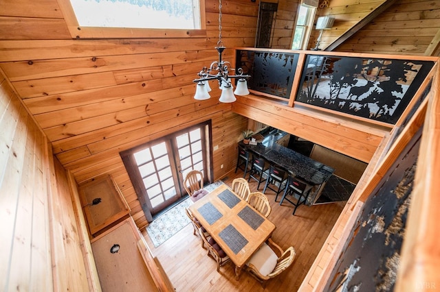 2766 Camden Rd, Big Island, VA 24526 - living room with a notable chandelier, hardwood / wood-style floors, and wood walls