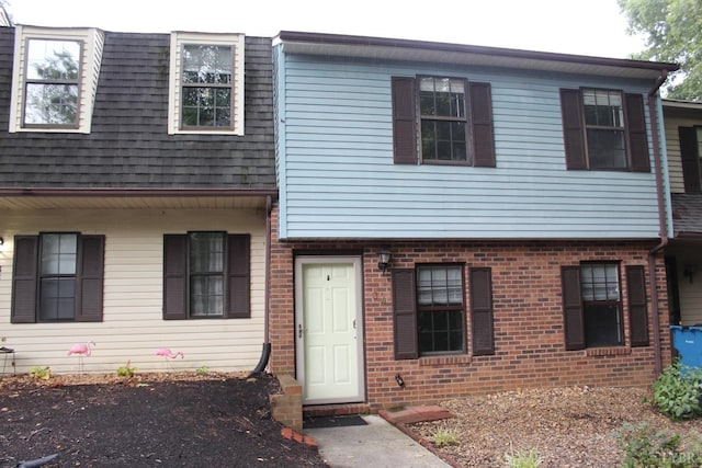 townhome / multi-family property featuring brick siding