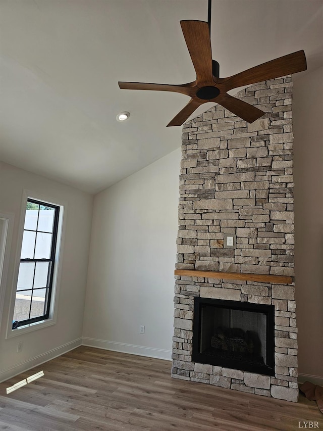 18 Grandset Dr, Forest, VA 24551 - unfurnished living room featuring lofted ceiling, a ceiling fan, wood finished floors, baseboards, and a stone fireplace