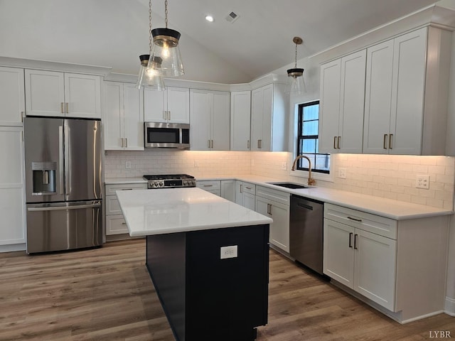 18 Grandset Dr, Forest, VA 24551 - kitchen with stainless steel appliances, a sink, lofted ceiling, a center island, and hanging light fixtures