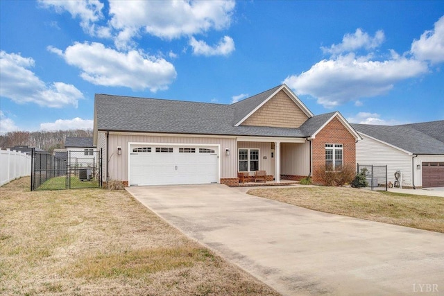 1270 Hupps Hill Ln, Forest, VA 24551 - view of front of home with concrete driveway, an attached garage, board and batten siding, a gate, and roof with shingles