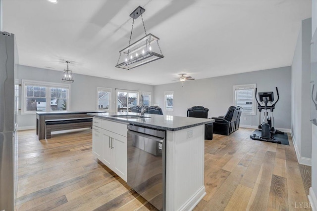 1270 Hupps Hill Ln, Forest, VA 24551 - kitchen featuring stainless steel appliances, white cabinetry, light wood-type flooring, a center island with sink, and ceiling fan