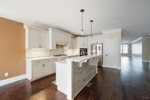 1060 Governors Ln, Forest, VA 24551 - kitchen featuring appliances with stainless steel finishes, under cabinet range hood, crown molding, dark wood-style floors, and backsplash