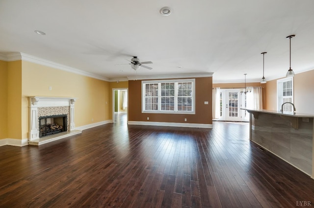1060 Governors Ln, Forest, VA 24551 - unfurnished living room featuring ceiling fan, a fireplace with raised hearth, crown molding, dark wood-style flooring, and baseboards