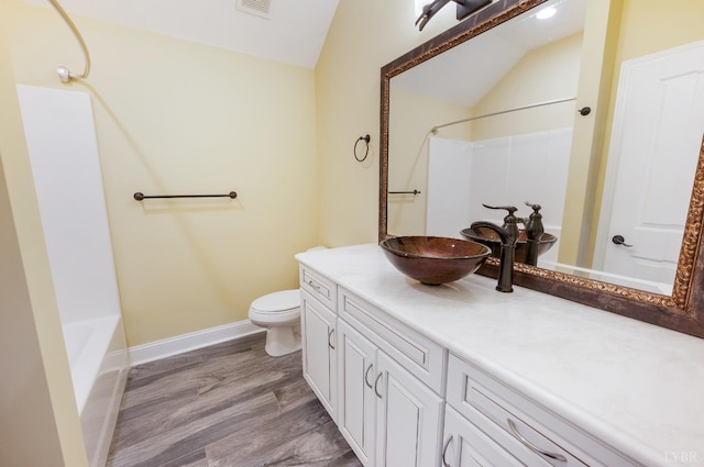 1060 Governors Ln, Forest, VA 24551 - full bathroom featuring vaulted ceiling, toilet, vanity, baseboards, and wood finished floors