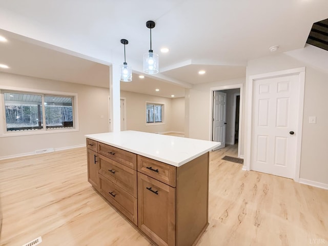 13273 Leesville Rd, Lynch Station, VA 24571 - kitchen featuring a center island, brown cabinetry, light wood-style floors, pendant lighting, and light countertops