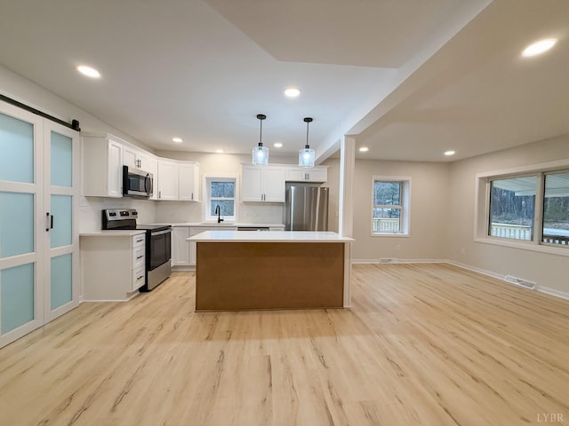 13273 Leesville Rd, Lynch Station, VA 24571 - kitchen featuring stainless steel appliances, a sink, recessed lighting, white cabinetry, and a kitchen island