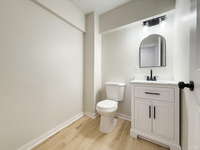 13273 Leesville Rd, Lynch Station, VA 24571 - half bathroom featuring baseboards, wood finished floors, vanity, and toilet