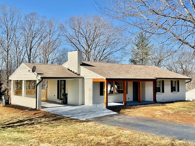 143 Lake Dr, Amherst, VA 24521 - view of front facade with a chimney, a porch, brick siding, and a shingled roof
