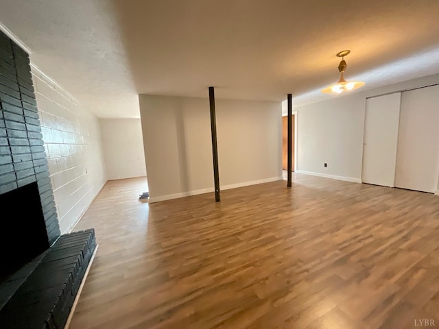 143 Lake Dr, Amherst, VA 24521 - finished below grade area featuring wood finished floors, a brick fireplace, and baseboards