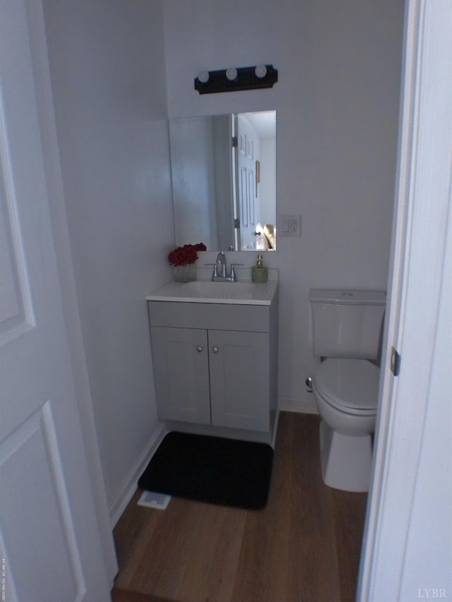 192 Main St, Madison Heights, VA 24572 - bathroom featuring wood finished floors, vanity, toilet, and baseboards