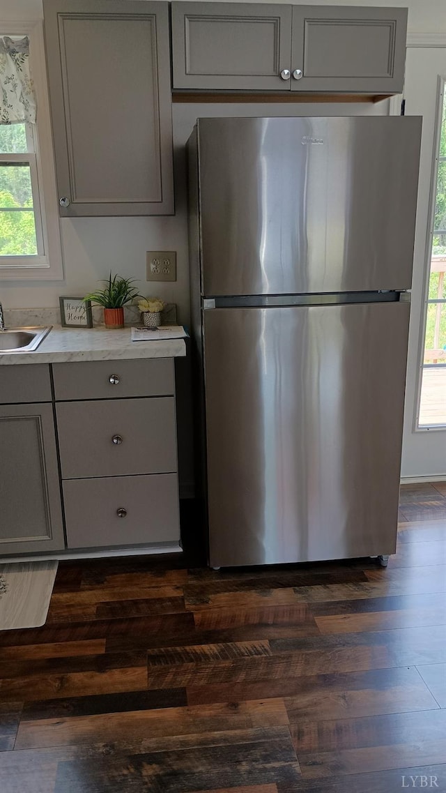 192 Main St, Madison Heights, VA 24572 - kitchen with freestanding refrigerator, gray cabinetry, light countertops, a sink, and dark wood finished floors