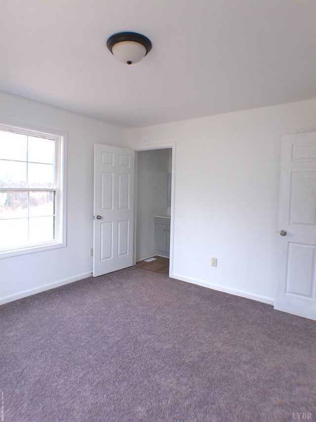 192 Main St, Madison Heights, VA 24572 - unfurnished bedroom with dark colored carpet and baseboards
