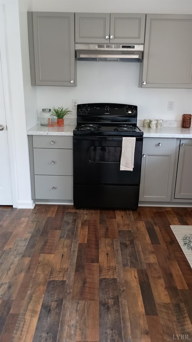 192 Main St, Madison Heights, VA 24572 - kitchen with gray cabinetry, black / electric stove, under cabinet range hood, and dark wood-type flooring