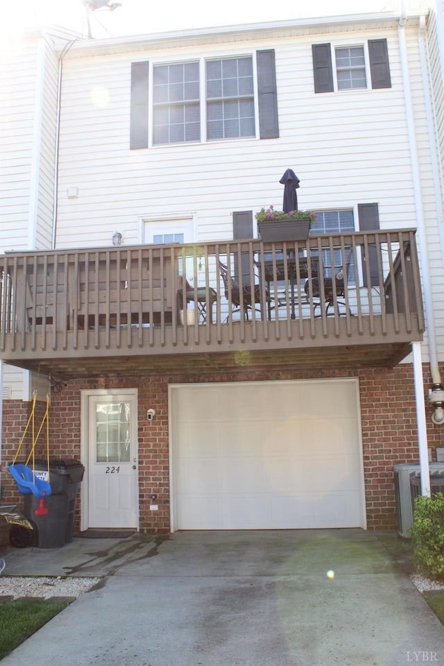 224 Duncraig Dr, Lynchburg, VA 24502 - back of property with driveway, brick siding, cooling unit, and an attached garage