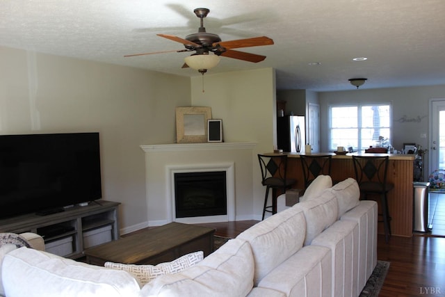 224 Duncraig Dr, Lynchburg, VA 24502 - living area with a fireplace, dark wood finished floors, a ceiling fan, a textured ceiling, and baseboards