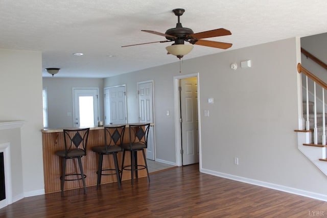 224 Duncraig Dr, Lynchburg, VA 24502 - kitchen with wood finished floors, a breakfast bar area, a peninsula, and ceiling fan