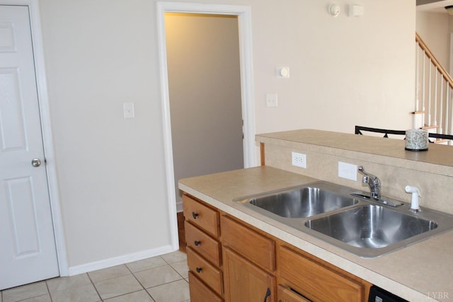 224 Duncraig Dr, Lynchburg, VA 24502 - kitchen featuring a sink, light tile patterned floors, light countertops, baseboards, and brown cabinets