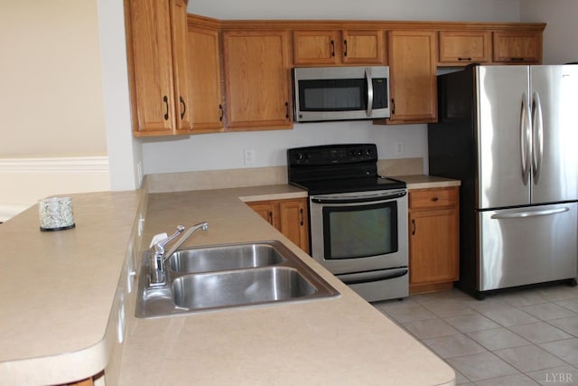 224 Duncraig Dr, Lynchburg, VA 24502 - kitchen featuring appliances with stainless steel finishes, a sink, light countertops, and brown cabinets