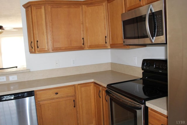 224 Duncraig Dr, Lynchburg, VA 24502 - kitchen with appliances with stainless steel finishes, light countertops, brown cabinets, and a ceiling fan