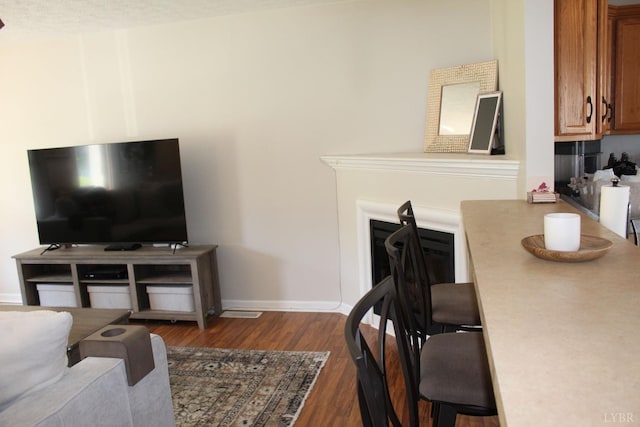 224 Duncraig Dr, Lynchburg, VA 24502 - living room featuring dark wood-style floors, baseboards, and a fireplace