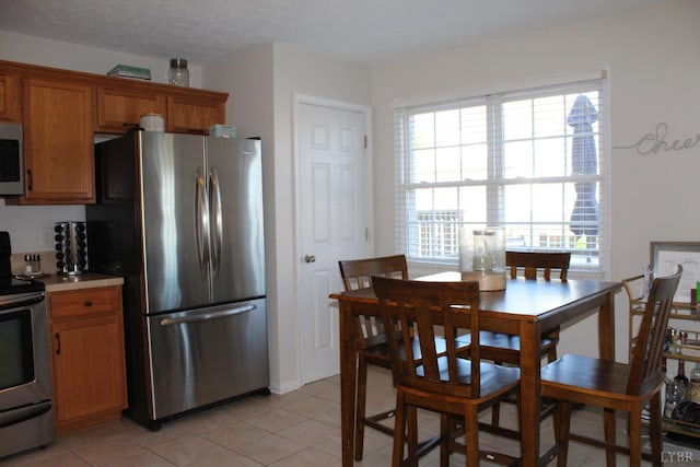 224 Duncraig Dr, Lynchburg, VA 24502 - kitchen featuring stainless steel appliances, brown cabinets, light tile patterned floors, and light countertops