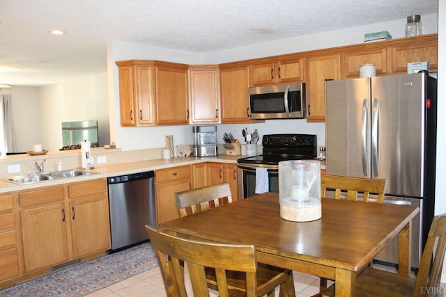 224 Duncraig Dr, Lynchburg, VA 24502 - kitchen with appliances with stainless steel finishes, a sink, light countertops, light tile patterned floors, and recessed lighting