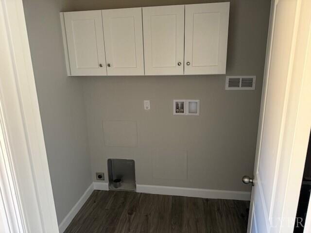 laundry area featuring washer hookup, visible vents, cabinet space, baseboards, and dark wood-style floors