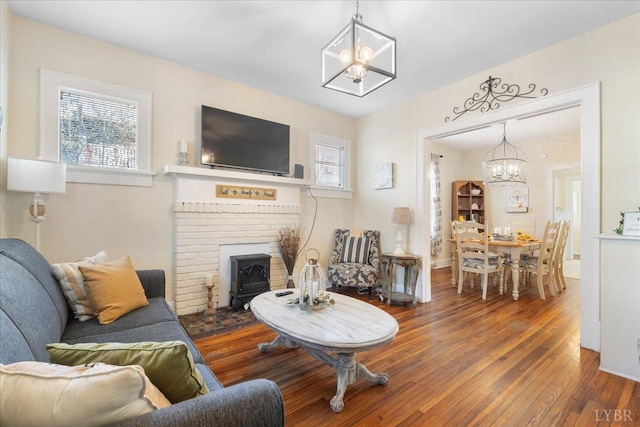 211 Warren Ave, Lynchburg, VA 24501 - living area featuring a chandelier, a wood stove, and hardwood / wood-style flooring