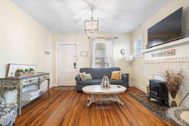 211 Warren Ave, Lynchburg, VA 24501 - living area featuring an inviting chandelier, a wood stove, wood finished floors, and baseboards