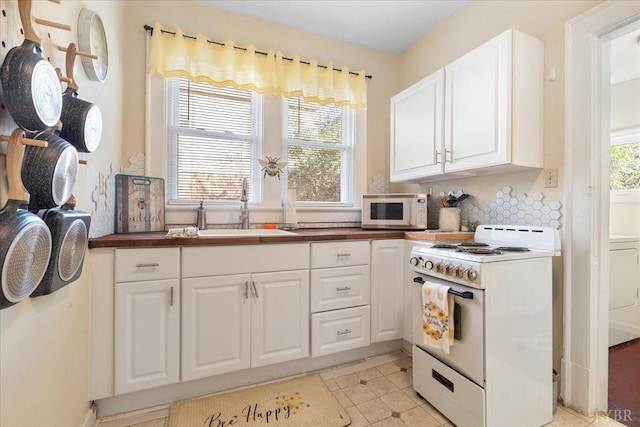 211 Warren Ave, Lynchburg, VA 24501 - kitchen with a sink, white appliances, a wealth of natural light, and white cabinetry