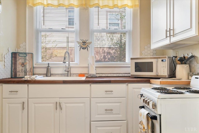211 Warren Ave, Lynchburg, VA 24501 - kitchen featuring white appliances, a sink, wood counters, white cabinetry, and tasteful backsplash