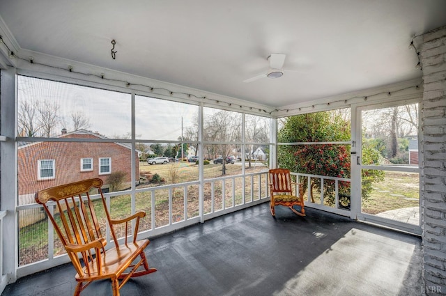 sunroom / solarium featuring a ceiling fan