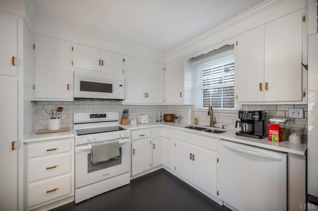 kitchen with white appliances, tasteful backsplash, light countertops, and a sink
