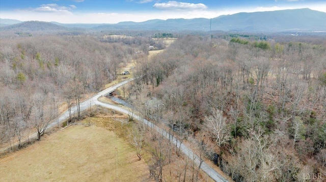 aerial view of property's location with mountains and a forest