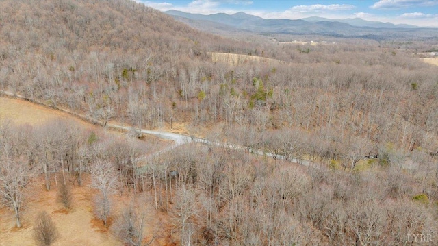 drone / aerial view of mountains and a heavily wooded area