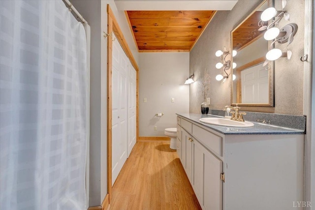 full bathroom with wood ceiling, wood finished floors, vanity, toilet, and baseboards