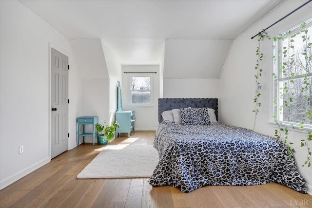 268 Leftwich Rd, Madison Heights, VA 24572 - bedroom featuring wood finished floors, vaulted ceiling, and baseboards