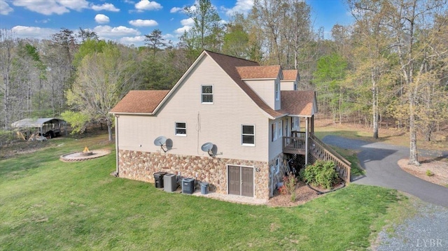 268 Leftwich Rd, Madison Heights, VA 24572 - view of property exterior featuring stone siding, a lawn, asphalt driveway, a forest view, and stairs