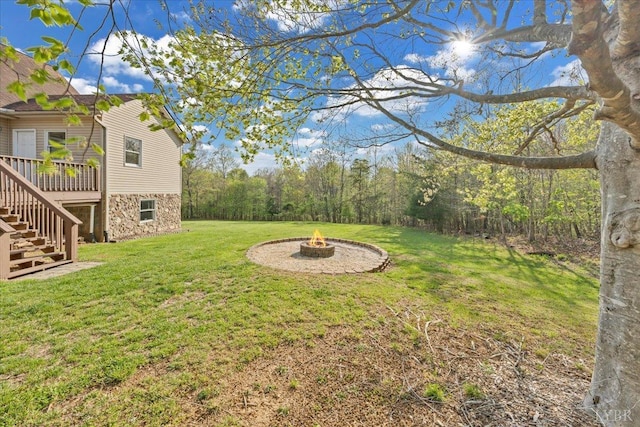 268 Leftwich Rd, Madison Heights, VA 24572 - view of green lawn featuring an outdoor fire pit, stairway, and a wooden deck