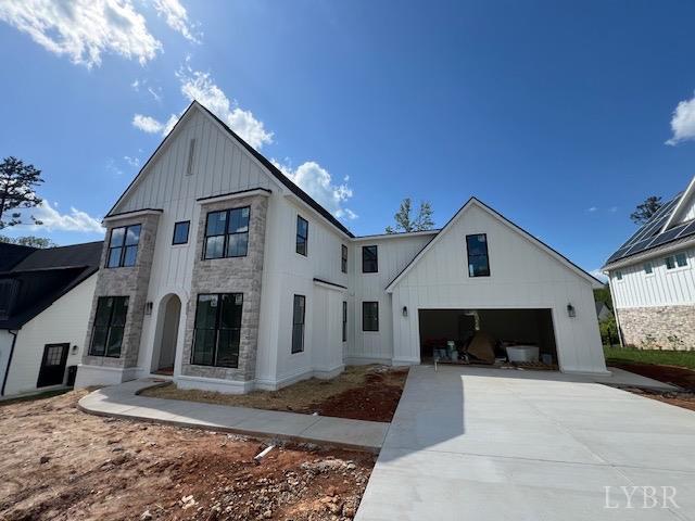 917 Elmwood Ave, Lynchburg, VA 24503 - view of front of home with board and batten siding, concrete driveway, and stone siding